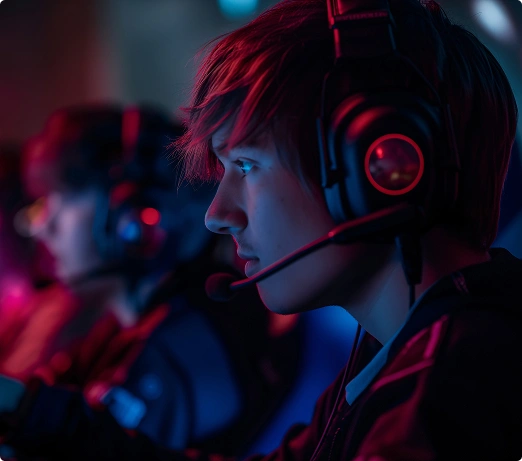 Een team van esportsers zit achter hun beeldschermen met een koptelefoon op en neemt deel aan een toernooi.